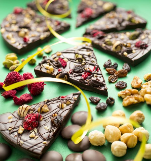 Decadent Dark chocolate pizza displayed as slices with ingredients and ribbon