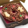 min Christmas chocolate pizza with Christmas shapes on it.