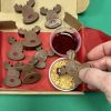 Dipping chocolate reindeer into biscuit crumb